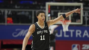 Jul 10, 2025; Las Vegas, NV, USA; San Antonio Spurs forward Carter Bryant (11) reacts to a teammates basket against the Philadelphia 76ers in the fourth quarter of their game at Thomas & Mack Center. Mandatory Credit: Candice Ward-Imagn Images