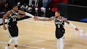 Dec 14, 2024; Las Vegas, Nevada, USA; Milwaukee Bucks guard Damian Lillard (0) and forward Giannis Antetokounmpo (34) react during the fourth quarter against the Atlanta Hawks in a semifinal of the 2024 Emirates NBA Cup at T-Mobile Arena. Mandatory Credit: Candice Ward-Imagn Images