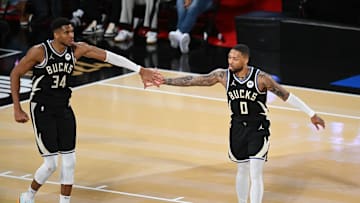 Dec 14, 2024; Las Vegas, Nevada, USA; Milwaukee Bucks guard Damian Lillard (0) and forward Giannis Antetokounmpo (34) react during the fourth quarter against the Atlanta Hawks in a semifinal of the 2024 Emirates NBA Cup at T-Mobile Arena. Mandatory Credit: Candice Ward-Imagn Images