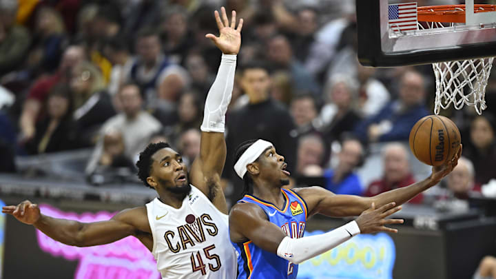 Oct 27, 2023; Cleveland, Ohio, USA; Oklahoma City Thunder guard Shai Gilgeous-Alexander (2) moves to the basket against Cleveland Cavaliers guard Donovan Mitchell (45) in the second quarter at Rocket Mortgage FieldHouse. Mandatory Credit: David Richard-Imagn Images Oct 27, 2023; Cleveland, Ohio, USA; Oklahoma City Thunder guard Shai Gilgeous-Alexander (2) moves to the basket against Cleveland Cavaliers guard Donovan Mitchell (45) in the second quarter at Rocket Mortgage FieldHouse. Mandatory Credit: David Richard-Imagn Images
