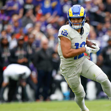 Oct 12, 2025; Baltimore, Maryland, USA; Los Angeles Rams wide receiver Puka Nacua (12) carries the ball against the Baltimore Ravens during the second quarter of the game at M&T Bank Stadium. Mandatory Credit: Peter Casey-Imagn Images