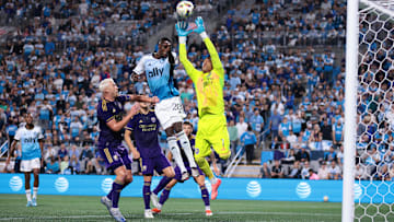 Nov 1, 2024; Charlotte, North Carolina, USA;  Orlando City goalkeeper Pedro Gallese (1) blocks a shot on goal by Charlotte FC midfielder Djibril Diani (28) during the second half at Bank of America Stadium. Mandatory Credit: Scott Kinser-Imagn Images