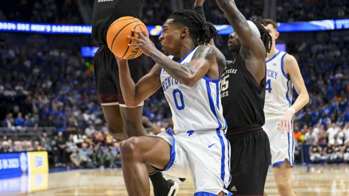 Mar 15, 2024; Nashville, TN, USA;  Kentucky Wildcats guard Rob Dillingham (0) gets fouled by Texas A&M Aggies forward Solomon Washington (13) and guard Manny Obaseki (35) during the second half at Bridgestone Arena. Mandatory Credit: Steve Roberts-USA TODAY Sports