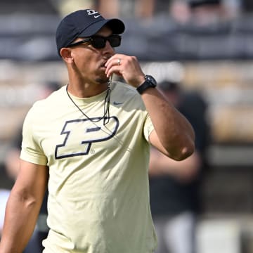 Purdue Boilermakers head coach Ryan Walters stands on the field