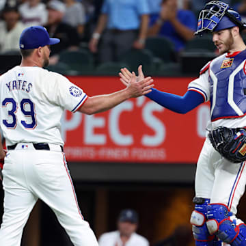 Sep 18, 2024; Arlington, Texas, USA;  Texas Rangers relief pitcher Kirby Yates (39) celebrates with Texas Rangers catcher Jonah Heim (28) after the game against the Toronto Blue Jays at Globe Life Field.