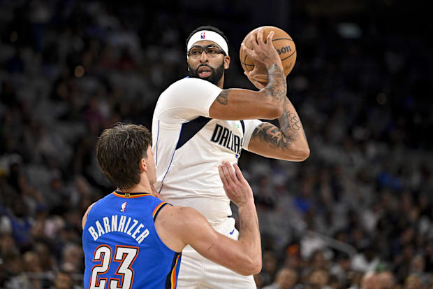 Mavericks forward/center Anthony Davis looks to move the ball past Thunder guard Brooks Barnhizer.