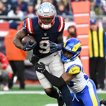 Nov 17, 2024; Foxborough, Massachusetts, USA; New England Patriots wide receiver Kayshon Boutte (9) is tackled by Los Angeles Rams safety Kamren Kinchens (26) during the second half at Gillette Stadium. Mandatory Credit: Eric Canha-Imagn Images