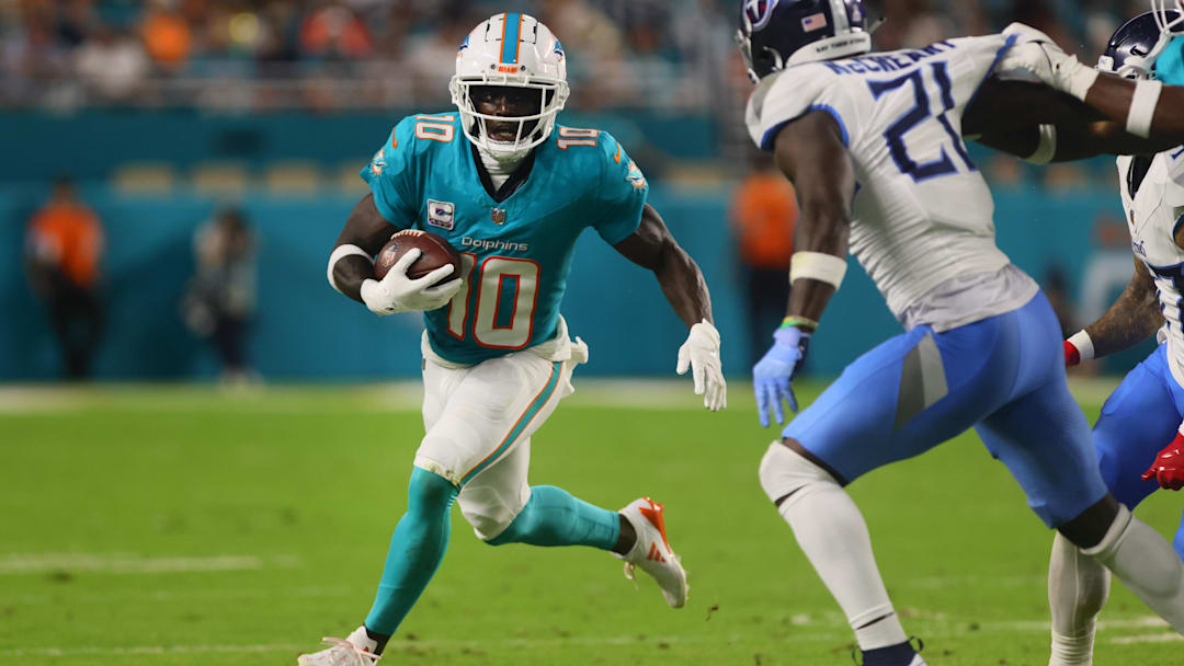 Miami Dolphins wide receiver Tyreek Hill (10) runs with the football against the Tennessee Titans during the third quarter at Hard Rock Stadium.
