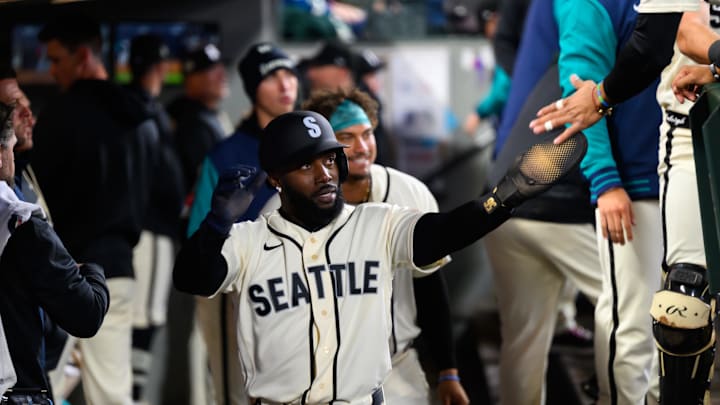 Mar 29, 2026; Seattle, Washington, USA; Seattle Mariners left fielder Randy Arozarena (56) celebrates in the dugout after scoring a run against the Cleveland Guardians during the fifth inning at T-Mobile Park. Mandatory Credit: Steven Bisig-Imagn Images