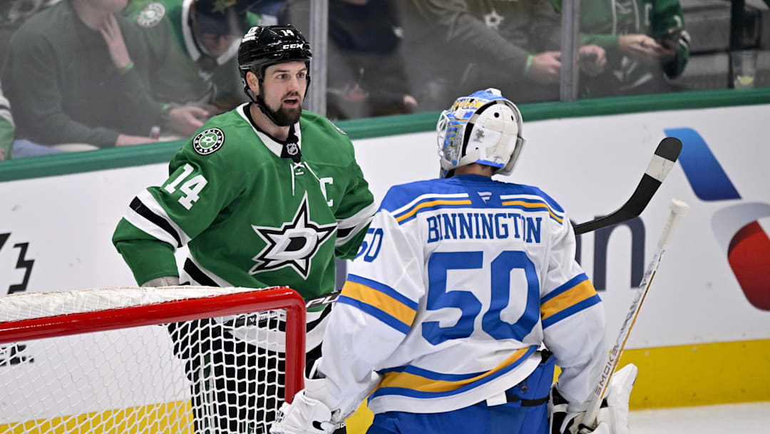 Feb 4, 2026; Dallas, Texas, USA; Dallas Stars left wing Jamie Benn (14) exchanges words with St. Louis Blues goaltender Jordan Binnington (50) during the first period at the American Airlines Center. Mandatory Credit: Jerome Miron-Imagn Images