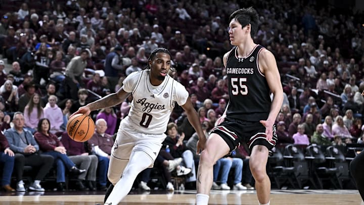 Jan 24, 2026; College Station, Texas, USA; Texas A&M Aggies guard Marcus Hill (0) controls the ball during the first half as South Carolina Gamecocks guard Mike Sharavjamts (55) defends at Reed Arena. Mandatory Credit: Maria Lysaker-Imagn Images 