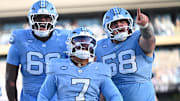 Nov 22, 2025; Chapel Hill, North Carolina, USA; North Carolina Tar Heels quarterback Gio Lopez (7) celebrates after scoring a touchdown during the first half against Duke Blue Devils at Kenan Stadium. Mandatory Credit: William Howard-Imagn Images