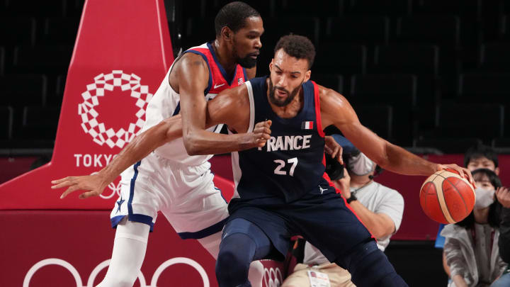 Aug 7, 2021; Saitama, Japan; France player Rudy Gobert (27) drives on USA player Kevin Durant (7) in the gold medal game during the Tokyo 2020 Olympic Summer Games at Saitama Super Arena. Mandatory Credit: Kyle Terada-USA TODAY Sports