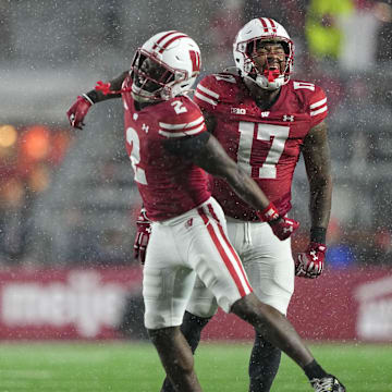Nov 8, 2025; Madison, Wisconsin, USA;  Wisconsin Badgers linebacker Darryl Peterson III (17) and cornerback Ricardo Hallman (2) celebrate following a play during the fourth quarter against the Washington Huskies at Camp Randall Stadium. Mandatory Credit: Jeff Hanisch-Imagn Images