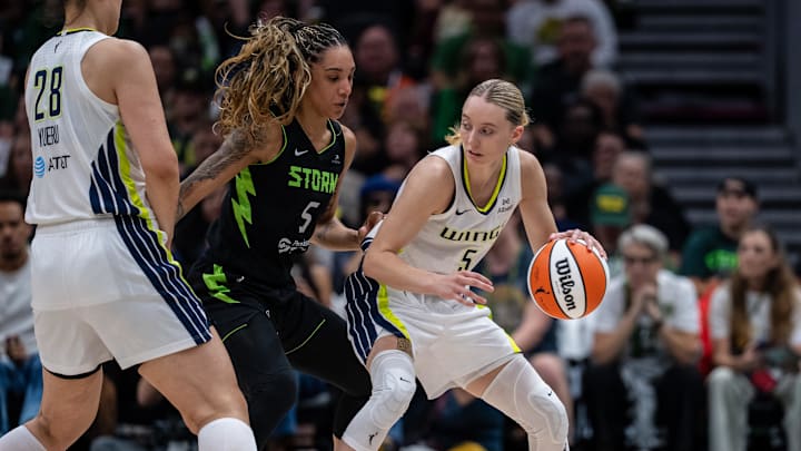 Dallas Wings guard Paige Bueckers dribbles the ball against Seattle Storm forward Gabby Williams. Dallas Wings guard Paige Bueckers dribbles the ball against Seattle Storm forward Gabby Williams.