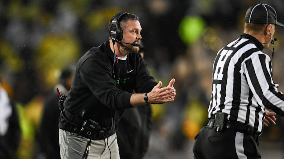 Oregon coach Dan Lanning calls a timeout during a game against Iowa.