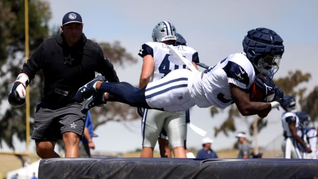 Dallas Cowboys running back Nathaniel Peat (36) jumps on a pad during training camp at the River Ridge