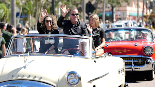 Coach John Peacock with his wife Georgia and daughter, Justice. It's a familiar site! A almost all green parade in the heart 