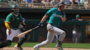  Seattle Mariners outfielder Luke Raley (20) hits an RBI triple against the Oakland Athletics in the fourth inning at Hohokam Stadium. 