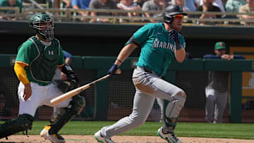  Seattle Mariners outfielder Luke Raley (20) hits an RBI triple against the Oakland Athletics in the fourth inning at Hohokam Stadium. 