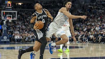 Dec 29, 2024; Minneapolis, Minnesota, USA; San Antonio Spurs forward Keldon Johnson (0) drives to the basket past Minnesota Timberwolves forward Josh Minott (8) in the second half at Target Center. Mandatory Credit: Jesse Johnson-Imagn Images