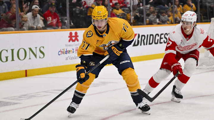 Mar 2, 2026; Nashville, Tennessee, USA;  Nashville Predators right wing Luke Evangelista (77) skates with the puck against the Detroit Red Wings during the second period at Bridgestone Arena. Mandatory Credit: Steve Roberts-Imagn Images