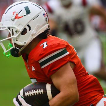 Sep 14, 2024; Miami Gardens, Florida, USA; Miami Hurricanes wide receiver Xavier Restrepo (7) runs with the football against the Ball State Cardinals during the first quarter at Hard Rock Stadium. Mandatory Credit: Sam Navarro-Imagn Images