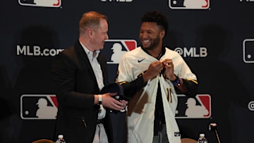 Dec 4, 2023; Nashville, TN, USA; Milwaukee Brewers general manager Matt Arnold presents Jackson Chourio with a team uniform and hat during the MLB 2023 Winter Meetings. Mandatory Credit: Kyle Schwab-Imagn Images