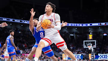 Mar 13, 2025; Kansas City, MO, USA; Arizona Wildcats forward Trey Townsend (4) drives to the basket around Kansas Jayhawks guard David Coit (8) during the first half at T-Mobile Center. Mandatory Credit: William Purnell-Imagn Images