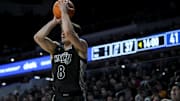 Dec 14, 2024; Cincinnati, Ohio, USA; Cincinnati Bearcats guard Connor Hickman (8) attempts a 3-point shot against the Xavier Musketeers in the second half at Fifth Third Arena. Mandatory Credit: Aaron Doster-Imagn Images