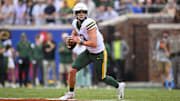 Sep 6, 2025; Dallas, Texas, USA; Baylor Bears quarterback Sawyer Robertson (13) rolls out with the ball during the game between the SMU Mustangs and the Baylor Bears at Gerald J. Ford Stadium. Mandatory Credit: Jerome Miron-Imagn Images