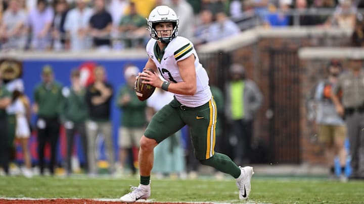 Sep 6, 2025; Dallas, Texas, USA; Baylor Bears quarterback Sawyer Robertson (13) rolls out with the ball during the game between the SMU Mustangs and the Baylor Bears at Gerald J. Ford Stadium. Mandatory Credit: Jerome Miron-Imagn Images