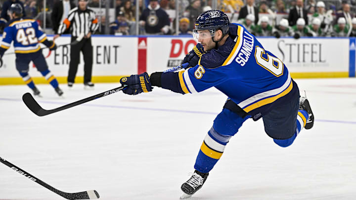Dec 27, 2023; St. Louis, Missouri, USA;  St. Louis Blues defenseman Marco Scandella (6) shoots and scores against the Dallas Stars during the second period at Enterprise Center. Mandatory Credit: Jeff Curry-Imagn Images