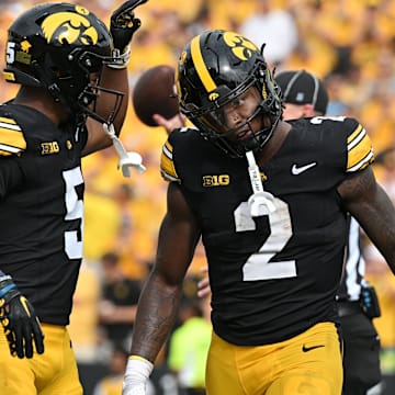 Sep 14, 2024; Iowa City, Iowa, USA; Iowa Hawkeyes running back Kaleb Johnson (2) reacts with wide receiver Jacob Gill (5) after running for a 4 yard touchdown against the Troy Trojans during the second quarter at Kinnick Stadium.