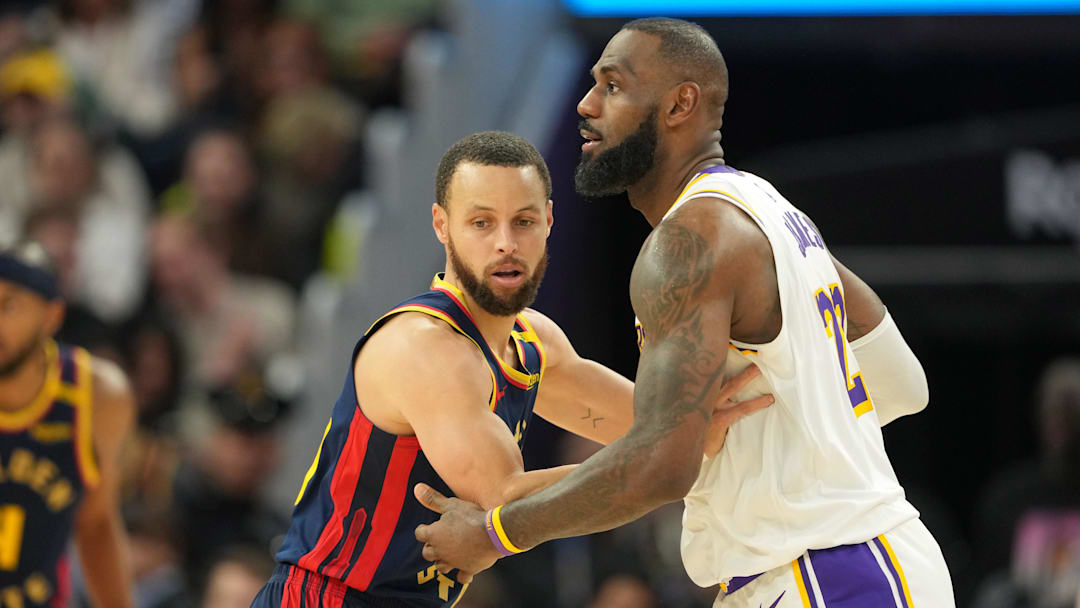 Jan 25, 2025; San Francisco, California, USA; Golden State Warriors guard Stephen Curry (left) defends against Los Angeles Lakers forward LeBron James (right) during the fourth quarter at Chase Center. Mandatory Credit: Darren Yamashita-Imagn Images