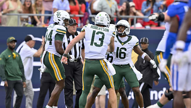 Baylor Bears wide receiver Josh Cameron (34) and quarterback Sawyer Robertson (13) and wide receiver Kobe Prentice celebrate