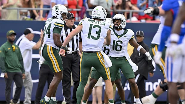Baylor Bears wide receiver Josh Cameron (34) and quarterback Sawyer Robertson (13), and wide receiver Kobe Prentice celebrate