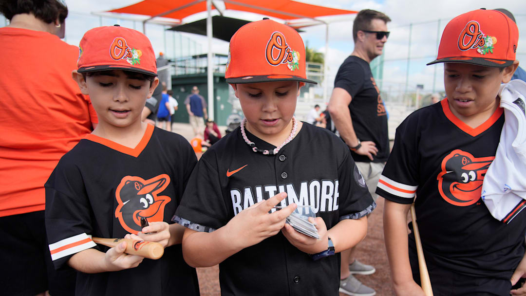 Orioles fans from Outer Banks, NC, from left, Izaiah Bravo, 10; Gabriel Bravo, 9; and Joey Robinson, 11 hope to get autographs from some of the players. The Baltimore Orioles began full-squad workouts this week at Ed Smith Stadium in Sarasota as the 2026 spring training season gets started. The Grapefruit Leage features 15 Major League Baseball teams that hold spring training in Florida. Games start this weekend and run up to opening day on March 25, 2026.