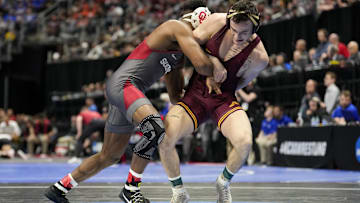 Mar 18, 2022; Detroit, MI, USA; Oklahoma wrestler Willie McDougald (red ankles) wrestles Minnesota wrestler Michael Blockhus (green ankles) in the 149 pound weight class during the NCAA Wrestling Championships at Little Cesars Arena. Mandatory Credit: Raj Mehta-Imagn Images