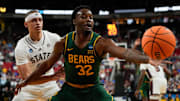 Mar 21, 2025; Raleigh, NC, USA; Baylor Bears guard Jalen Celestine (32) reaches for the ball defended by Mississippi State Bulldogs guard Riley Kugel (2) during the first half in the first round of the NCAA Tournament at Lenovo Center. Mandatory Credit: Bob Donnan-Imagn Images
