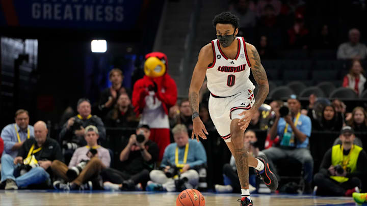Louisville Cardinals forward James Scott (0) brings the ball up the court in the first half at Spectrum Center. Louisville Cardinals forward James Scott (0) brings the ball up the court in the first half at Spectrum Center.