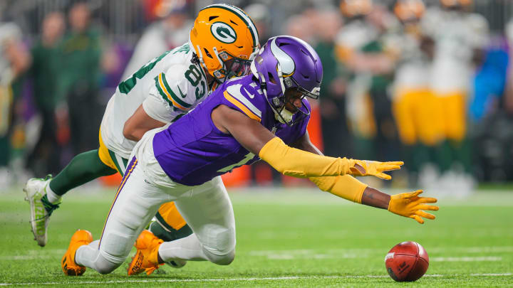 Dec 31, 2023; Minneapolis, Minnesota, USA; Minnesota Vikings cornerback NaJee Thompson (11) recovers a dropped punt from Green Bay Packers wide receiver Samori Toure (83) in the fourth quarter at U.S. Bank Stadium.