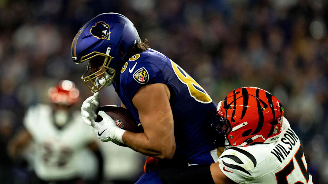 Baltimore Ravens tight end Charlie Kolar (88) is tackled by Cincinnati Bengals linebacker Logan Wilson (55) in the second quarter of the NFL game at M&T Banks Stadium in Baltimore on Thursday, Nov. 7, 2024.