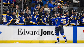 Nov 5, 2024; St. Louis, Missouri, USA;  St. Louis Blues center Jordan Kyrou (25) is congratulated by teammates after scoring against the Tampa Bay Lightning during the third period at Enterprise Center. Mandatory Credit: Jeff Curry-Imagn Images