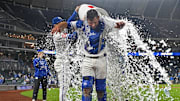 May 7, 2025; Kansas City, Missouri, USA;  Kansas City Royals catcher Luke Maile (15) reacts after getting doused with ice water from teammates center fielder Kyle Isbel (28) and right fielder Cavan Biggio (18) after beating the Chicago White Sox at Kauffman Stadium. Mandatory Credit: Peter Aiken-Imagn Images
