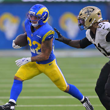 Nov 2, 2025; Inglewood, California, USA; Los Angeles Rams running back Blake Corum (22) carries the ball as New Orleans Saints safety Justin Reid (21) defends during the second half at SoFi Stadium. Mandatory Credit: Jayne Kamin-Oncea-Imagn Images