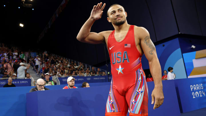 Aaron Brooks  waves to the crowd before a match in the men's freestyle 86kg weight class at the 2024 Paris Olympics. 