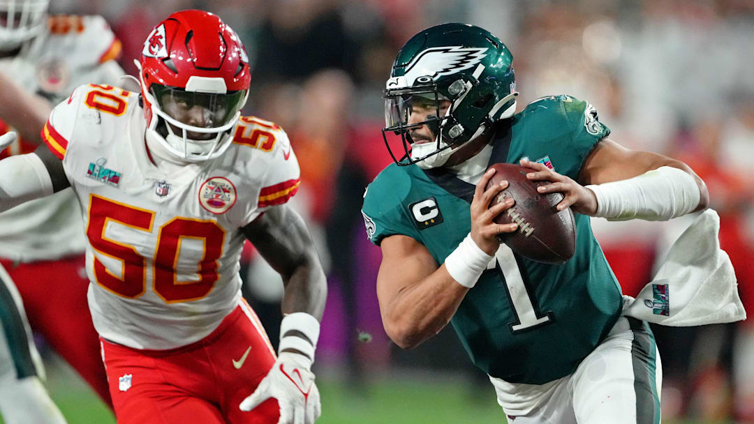 Feb 12, 2023; Glendale, Arizona, US; Philadelphia Eagles quarterback Jalen Hurts (1) scrambles with the ball against Kansas City Chiefs linebacker Willie Gay (50) during the fourth quarter of Super Bowl LVII at State Farm Stadium. Mandatory Credit: Kirby Lee-Imagn Images