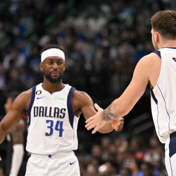 Dec 29, 2022; Dallas, Texas, USA; Dallas Mavericks guard Luka Doncic (77) greets guard Kemba Walker (34) as Walker enters the game against the Houston Rockets during the first half at the American Airlines Center. Mandatory Credit: Jerome Miron-USA TODAY Sports