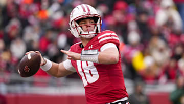 Nov 29, 2024; Madison, Wisconsin, USA;  Wisconsin Badgers quarterback Braedyn Locke (18) throws a pass during the second quarter against the Minnesota Golden Gophers at Camp Randall Stadium. Mandatory Credit: Jeff Hanisch-Imagn Images